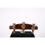 A MAHOGANY WALL MOUNTED THREE HOOK COAT HANGER each hook in the form of a horses head 24cm x 60cm