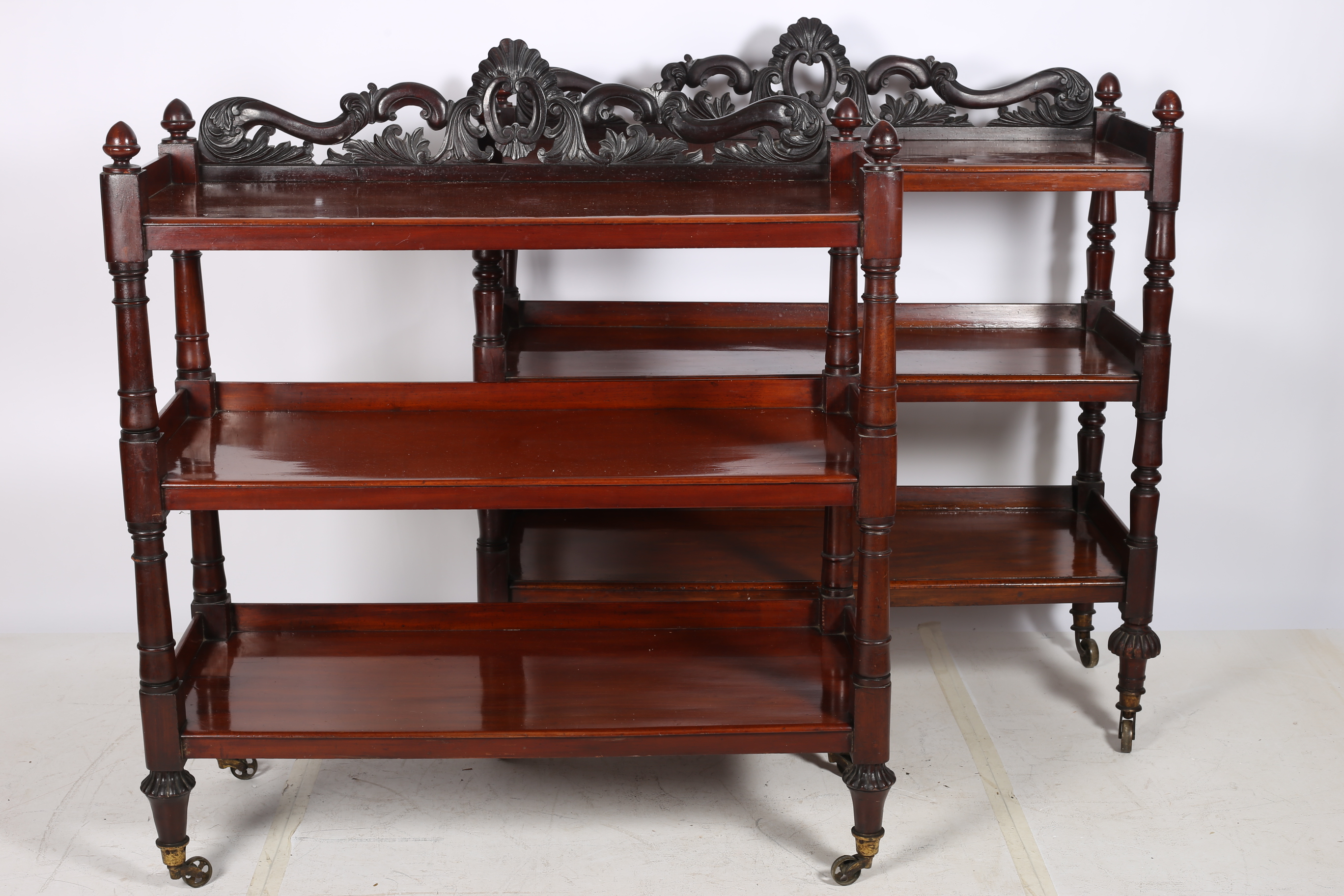 A MATCHED PAIR OF 19TH CENTURY MAHOGANY THREE TIER DUMB WAITERS each with a pierced carved back