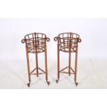 A PAIR OF WROUGHT IRON JARDINIERE STANDS each of circular form with openwork frieze raised on