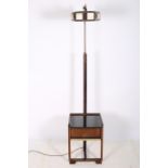 A RETRO OAK AND BRASS STANDARD LAMP with multicoloured glass shade the oak and brass column above a
