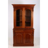 A VICTORIAN DESIGN MAHOGANY TWO DOOR LIBRARY BOOKCASE the moulded cornice above a pair of bevelled