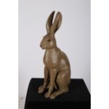 A COMPOSITION AND POLYCHROME FIGURE modelled as a hare shown seated 60cm (h)