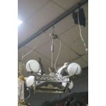 AN ART DECO PLATED FOUR LIGHT CENTRE LIGHT the square pierced frame with four opaque white globe