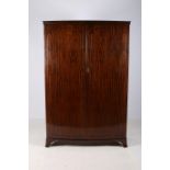 A HEPPLEWHITE DESIGN MAHOGANY TWO DOOR WARDROBE of rectangular bowed outline the interior with