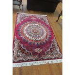 A PERSIAN GROUND PATTERNED RUG decorated overall with flower heads and foliage 250cm x 150cm