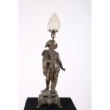 A 19TH CENTURY SPELTER FIGURAL TABLE LAMP modelled as a courtier shown standing holding a torch