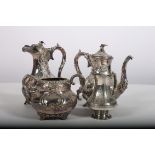 A VICTORIAN FOUR PIECE SILVER PLATED AND EMBOSSED COFFEE SET comprising two coffee pots cream jug