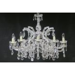 A FINE CONTINENTAL CUT GLASS TEN BRANCH CHANDELIER hung with faceted pendants and drops