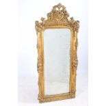 A 19TH CENTURY GILTWOOD AND GESSO MIRROR the rectangular arched plate within a flower head and