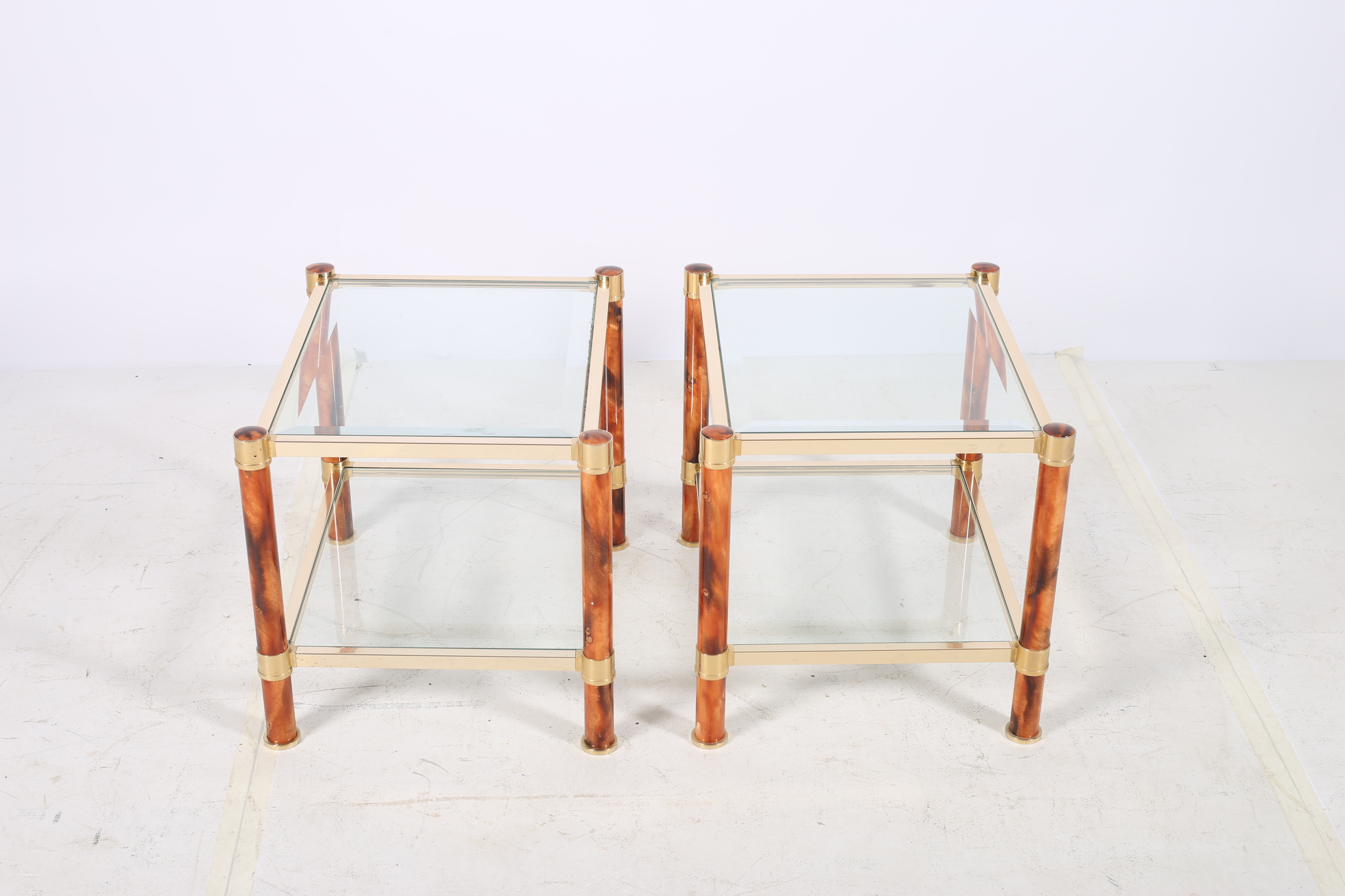 A PAIR OF BRASS AND SIMULATED WALNUT DESIGNER LAMP TABLES each of rectangular form the shaped top