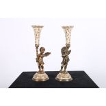 A PAIR OF CONTINENTAL PORCELAIN AND GILT BRASS CANDLESTICKS each modelled as a winged cherub