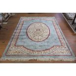 A LIGHT BLUE AND BEIGE GROUND PATTERNED RUG the central panel filled with stylized foliage and