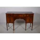 A HEPPLEWHITE DESIGN MAHOGANY AND ROSEWOOD CROSS BANDED SIDEBOARD of serpentine outline the shaped