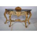 A CONTINENTAL GILTWOOD CONSOLE TABLE of serpentine outline surmounted by a black veined marble top