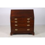 A GEORGIAN OAK BUREAU the rectangular top above a hinged writing slope containing pigeon holes and