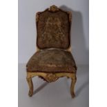 A 19TH CENTURY CARVED GILTWOOD AND NEEDLE WORK UPHOLSTERED SIDE CHAIR the foliate and C-scroll top