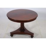 A 19TH CENTURY MAHOGANY OCCASIONAL TABLE the circular moulded top above a cylindrical column on