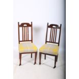 A PAIR OF ARTS AND CRAFTS MAHOGANY SIDE CHAIRS each with a shaped top rail and vertical splats with