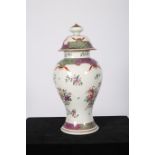 A CONTINENTAL PORCELAIN LIDDED VASE of baluster form the white ground decorated with stylized