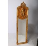 A CONTINENTAL GILT FRAMED MIRROR the rectangular bevelled glass plate within a foliate and flower