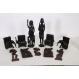 A PAIR OF CARVED EBONY FIGURES modelled as a female and her companion together with four ebonised