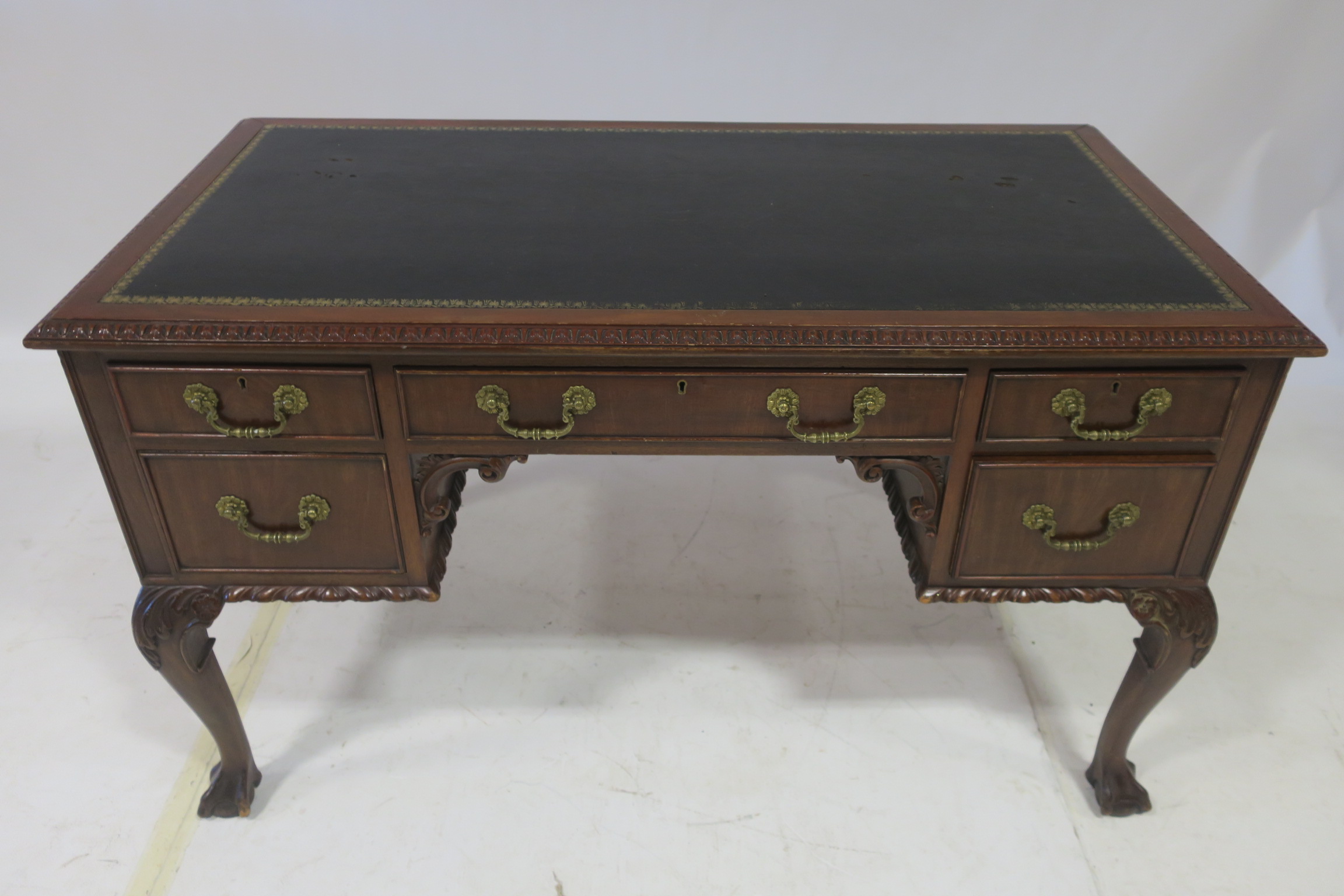 A GOOD CHIPPENDALE DESIGN MAHOGANY DESK of rectangular outline the shaped top with tooled leather