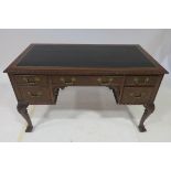 A GOOD CHIPPENDALE DESIGN MAHOGANY DESK of rectangular outline the shaped top with tooled leather