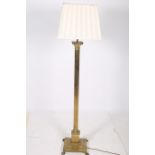 A BRASS CORINTHIAN COLUMN FLOOR STANDARD LAMP with reeded column above a square step base with