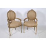 A PAIR OF CONTINENTAL CARVED WOOD AND HESSIAN UPHOLSTERED SALOON CHAIRS each with an oval
