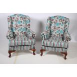 A PAIR OF QUEEN ANNE DESIGN MAHOGANY AND UPHOLSTERED WING CHAIRS with scroll over arms and loose