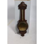 AN ARTS AND CRAFTS OAK BANJO BAROMETER with brass and silvered dials 81cm (h)