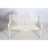 A CAST IRON GARDEN SEAT the rectangular arched pierced back with slatted seat and scroll arms on