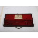 A LEATHER AND CANVAS BOUND GUN CASE with carrying handle bears label Holland & Hollands Ltd 98 New