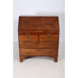 A GEORGIAN MAHOGANY BUREAU the rectangular top above a hinged writing slope containing pigeon holes