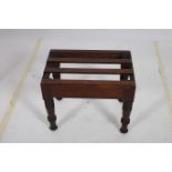 A 19TH CENTURY MAHOGANY CASE REST the slatted top raised on ring turned legs 45cm (h) x 55cm (w) x