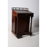 A 19TH CENTURY ROSEWOOD DAVENPORT the superstructure with moulded gallery above a tooled leather