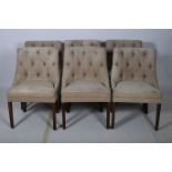 A SET OF SIX HARDWOOD AND UPHOLSTERED DINING CHAIRS each with a tub shaped upholstered back and