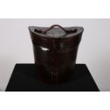 A SIMULATED LEATHER HAT BOX of ovoid tapering form with carrying handle 27cm (h)
