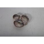 A SILVER PLATED SHELL SHAPED HORS D'OEURVE DISH with roped handle on shell feet