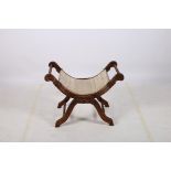 A STAINED WOOD CARVED FRAME STOOL the bowed seat with upholstered panel on reeded splayed legs