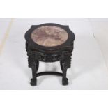 AN ORIENTAL HARDWOOD STAND of serpentine outline the shaped top with veined marble inset raised on