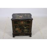 A CONTINENTAL EBONISED POLYCHROME SIDE CABINET of serpentine outline the shaped top with frieze