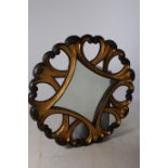 A CONTINENTAL GILTWOOD AND POLYCHROME MIRROR the diamond shaped bevelled glass plate within a