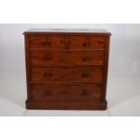 A 19TH CENTURY MAHOGANY CHEST of rectangular outline the shaped top above two short and three long