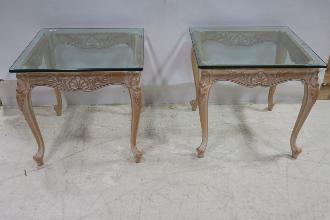 A PAIR OF LIMEWOOD AND GLAZED END TABLES each of rectangular form with plate glass top above a