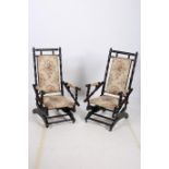A PAIR OF MAHOGANY ROCKING CHAIRS with turned frames and upholstered back and seat and arm rests on