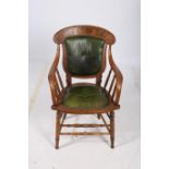 AN OAK FRAMED LIBRARY CHAIR CIRCA 1950s the shaped top rail with button upholstered panel and seat