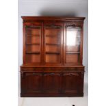 A GOOD 19TH CENTURY MAHOGANY THREE DOOR LIBRARY BOOKCASE the outswept moulded cornice above three