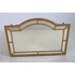 A CONTINENTAL GILTWOOD AND GESSO COMPARTMENTED OVERMANTLE MIRROR of rectangular arch form with bead