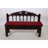 A GOTHIC DESIGN OAK BENCH the pierced and carved top rail with bobbin splats above a panelled seat